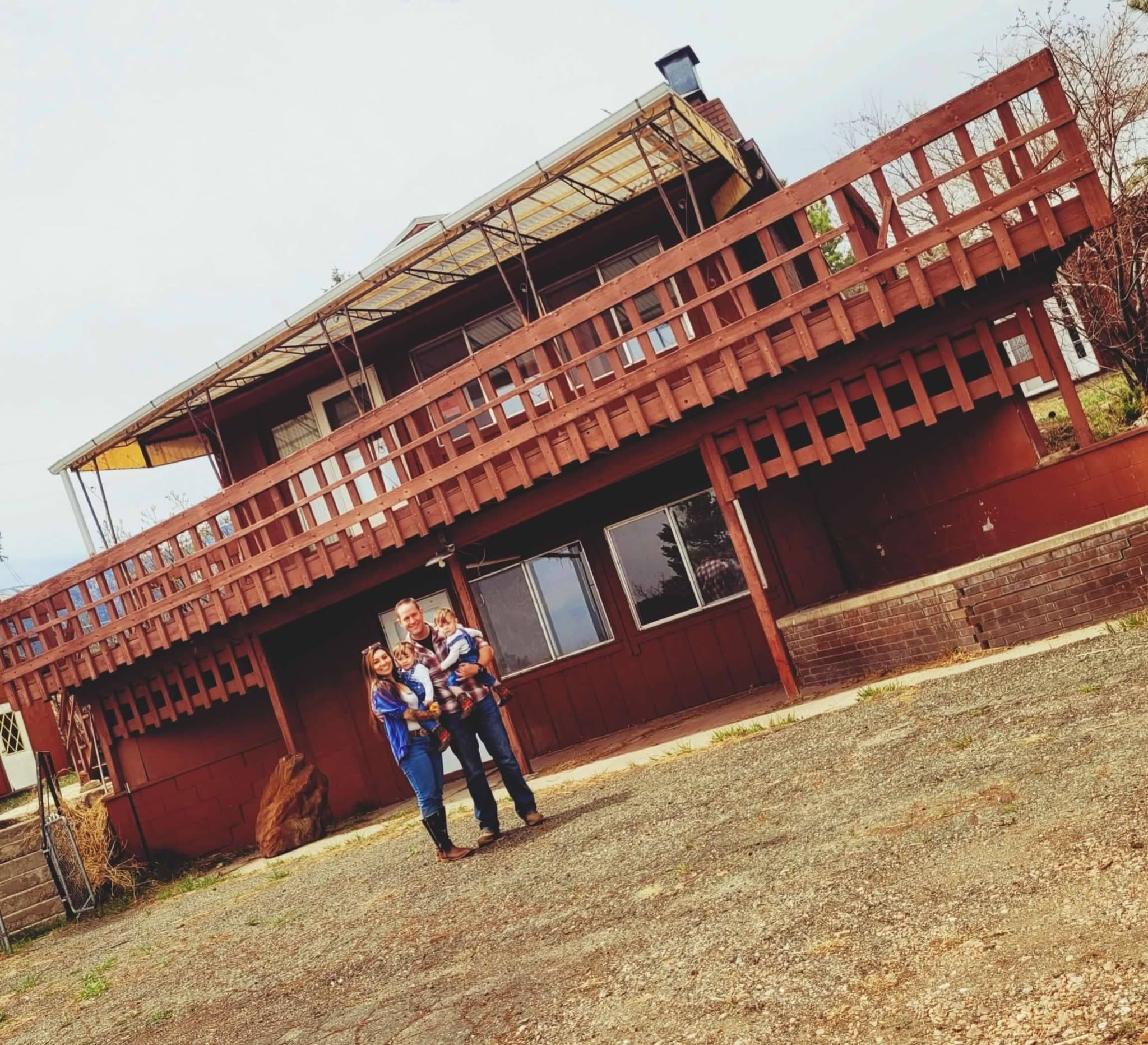 Family standing in front of their home before the Aspen Acres Fire